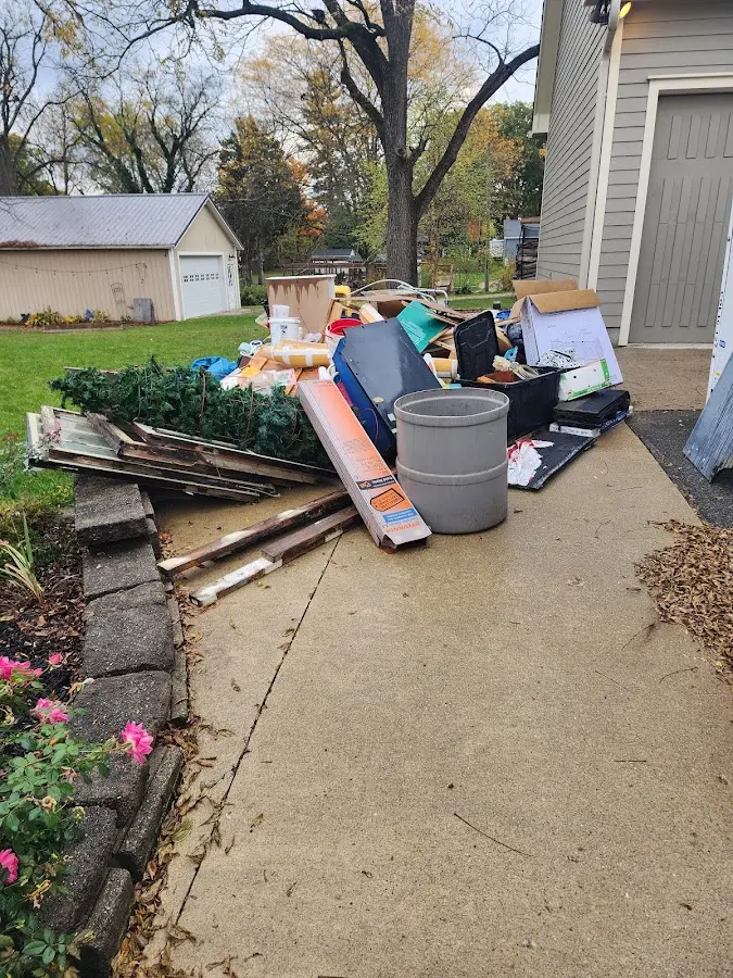 Dumpster being loaded with debris for 3 Yard Dumpster Rental in Grafton